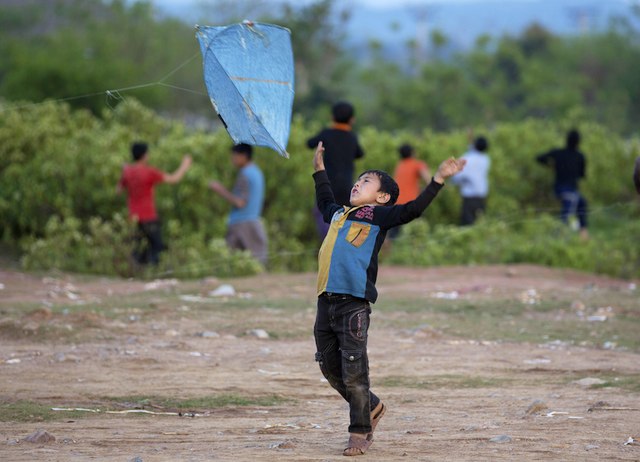 An Afghan refugee child flies a kite in the suburbs of Islamabad, Pakistan, March 15, 2016. AP/B.K. Bangash