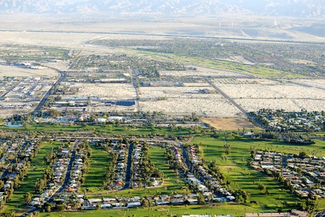 In this April 3, 2015, aerial photo, lush green golf courses border the edge of the desert in Palm Springs, Calif. The Agua Caliente tribe is pushing for a role in managing groundwater in the region, which has been severely depleted by decades of development.Chris Carlson, Associated Press