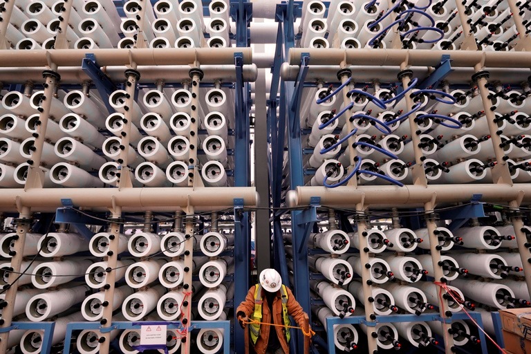 A worker climbs stairs among some of the 2,000 pressure vessels used to convert seawater into fresh water through reverse osmosis in the western hemisphere’s largest desalination plant in Carlsbad, Calif. More than a dozen desal plants are proposed for the California coast but delays at one such plant in Huntington Beach, Calif., over permitting could impact plans for construction at others. (Gregory Bull, AP)