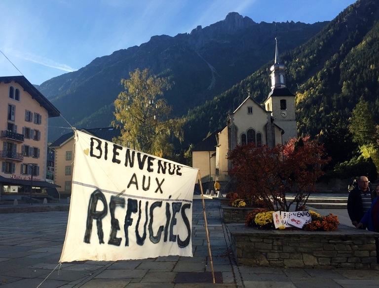 A banner set up in the main square of Chamonix, French Alps, reads: "Welcome to Refugees." Two days later, the migrants camp known as "the jungle" in Calais, France, would be dismantled, Oct. 22, 2016 (AP/Bertrand Combaldieu)