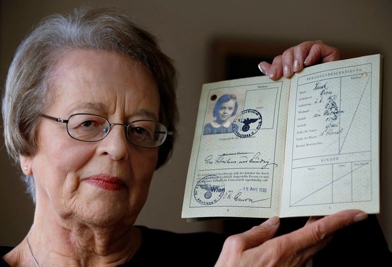 Eve Willman holds a copy of her 1939 German passport at her home in London. Willman was brought to England by Kindertransport from Austria to escape Nazi persecution. (AP/Kirsty Wigglesworth)