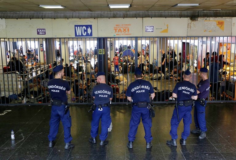 Hungarian policemen guard an entrance to Keleti railway station in Budapest as hundreds of migrants try to board trains to Germany. (AP/Petr David Josek)