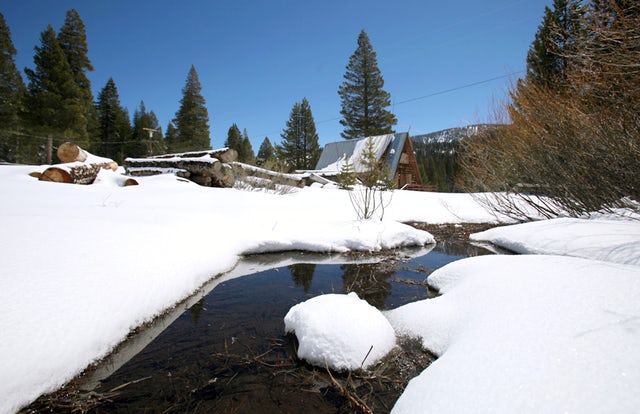 A stream seen running through snow covered banks near the site of the Department of Water Resources snow survey at Echo Summit, Calif. Over the past century, snowpack runoff has decreased due to warmer winters and earlier arrival of spring.Rich Pedroncelli, AP