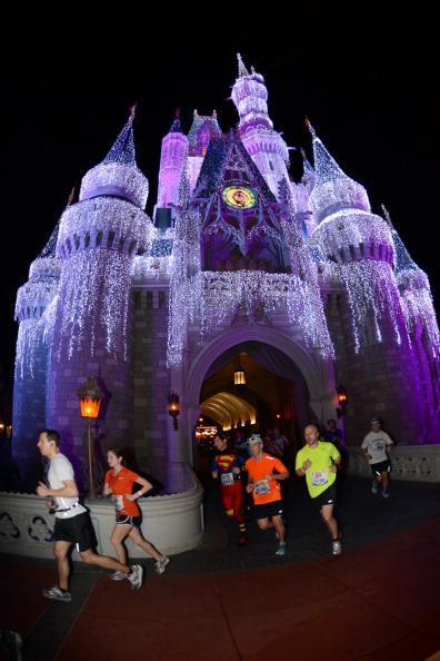 LAKE BUENA VISTA, FL - JANUARY 13:  In this handout image provided by Disney Parks, athletes run through Cinderella Castle in the Magic Kingdom park January 13, 2013 during the 20th Annual Walt Disney World Marathon presented by Cigna at Walt Disney World Resort in Lake Buena Vista, Fla. The 26.2-mile race coursed through all four Disney theme parks and through the Walt Disney World Speedway and ESPN Wide World of Sports Complex. A record 65,000 runners took part this year in a variety of Walt Disney World Marathon Weekend events, including the Family Fun Run 5K, Mickey Mile and runDisney Kids Races, along with the half and full marathons. (Photo by Todd Anderson/Disney Parks via Getty Images)