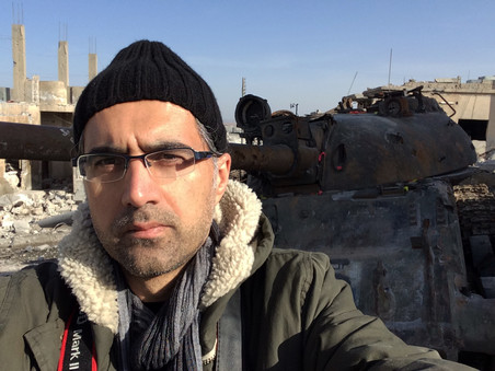 Selfie of filmmaker Reber Dosky in Kobani, in front of a tank captured by ISIS.