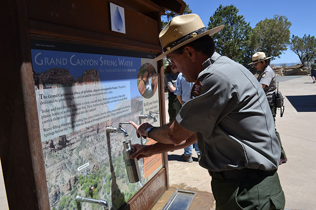 The superintendent of Grand Canyon National Park fills up a reusable water bottle at a hydration station. In 2012, Grand Canyon National Park banned the sale of plastic water bottles inside the park. (Photo: Corporate Accountability International)
