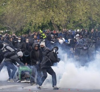 Masked youths face off with French police during a demonstration against the French labour law proposal in Paris, France, as part of a nationwide labor reform protests and strikes, April 28, 2016. REUTERS/Philippe Wojazer