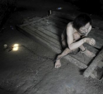 Tong Jieping, 44-year-old mentally disabled patient, is chained by his foot inside his room, in Qunxing village of Wangjiang county, Anhui province, China, July 14, 2015. Tong was diagnosed mentally ill when he was in his 20s. His parents, both in their 70s, could not afford the medical treatments so they had to lock him up in chains to prevent him from running away, according to Tong's family. REUTERS/Stringer CHINA OUT. NO COMMERCIAL OR EDITORIAL SALES IN CHINA         TPX IMAGES OF THE DAY      - RTX1KA0W