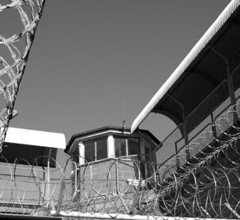 Barbed wire surrounds a tower in Maitland Jail, a former Australian prison, in a photo taken on July 17, 2006. (Photo: Weapons of Mass Distortion)