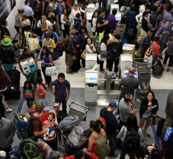 Delayed passengers inside Terminal 7 at Los Angeles International Airport line up to go through TSA security check following a false alarm event in Los Angeles, California U.S August 28, 2016.  REUTERS/Bob Riha Jr