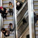 Shoppers ride escalators at the Beverly Center mall in Los Angeles, California November 8, 2013. REUTERS/David McNew/File Photo
