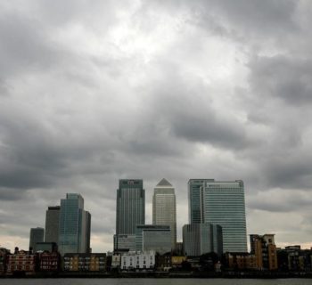 Storm clouds are seen above the Canary Wharf financial district in London, Britain, August 3, 2010.  REUTERS/Greg Bos/File Photo