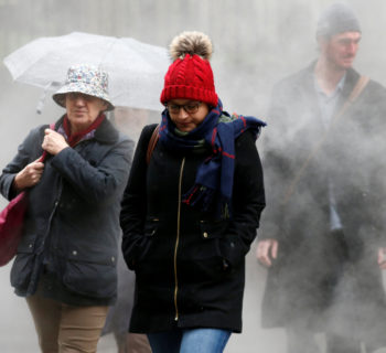 People walk through steam in the financial district during a winter nor'easter in New York City, U.S., January 24, 2017.  REUTERS/Brendan McDermid