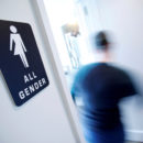 FILE PHOTO - A bathroom sign welcomes both genders at the Cacao Cinnamon coffee shop in Durham, North Carolina, United States on May 3, 2016.   REUTERS/Jonathan Drake/File Photo