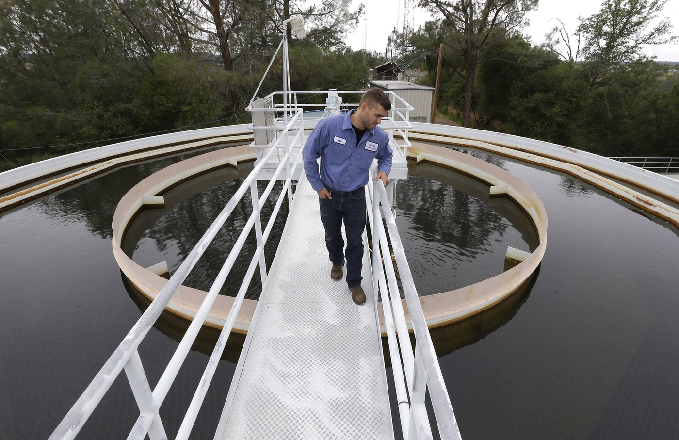 Ione Water Treatment Plant operator Mike Thompson does a visual inspection of a water holding tank at the facility in Ione, Calif. The Amador Water Agency, which operates the plant, is planning to use funds from the Department of Water Resources to help pay for the installation of another layer of water filtration at the facility that would enable them to reuse water that has been used to clean the treatment plant’s filtering system. (Rich Pedroncelli, AP)