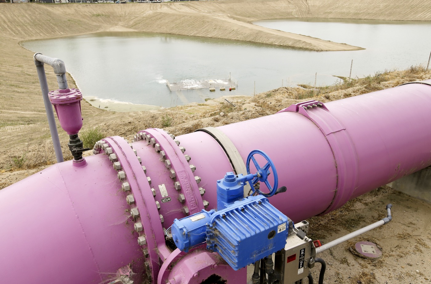 In this May 6, 2016 file photo, a pipe feeds recycled wastewater to a holding pond to recharge an underground aquifer at the Orange County Water District recharge facility in Anaheim, Calif. (Chris Carlson, AP)