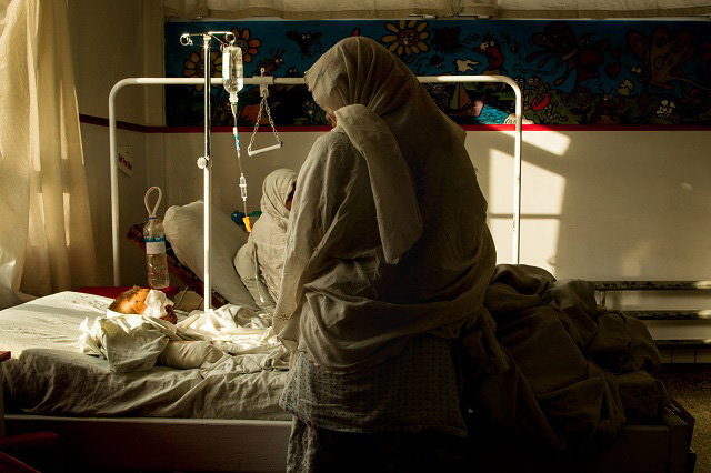 Alisina, 4, is watched over by her mother inside Emergency Hospital in Kabul, Afghanistan, on May 2, 2017. Alisina was playing outside of her home in Maidan Wardak when she found a land mine and it went off. The explosion wounded her in the face, damaging both of her eyes. She also took shrapnel to the chest and hands. Her thumb and third finger required traumatic amputation. (Photo: Ivan Armando Flores)