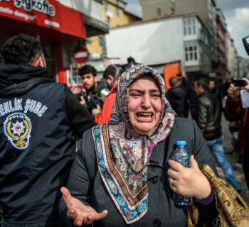 A woman cries as Turkish anti-riot police officers disperse supporters in front of the headquarters of the Turkish daily newspaper Zaman in Istanbul on March 5, 2016, after Turkish authorities seized the headquarters in a midnight raid.
Turkish authorities were on March 5 in control of the newspaper staunchly opposed to President Recep Tayyip Erdogan after using tear gas and water cannon to seize its headquarters in a dramatic raid that raised fresh alarm over declining media freedoms. Police fired the tear gas and water cannon just before midnight at a hundreds-strong crowd that had formed outside the headquarters of the Zaman daily in Istanbul following a court order issued earlier in the day. / AFP / OZAN KOSEOZAN KOSE/AFP/Getty Images