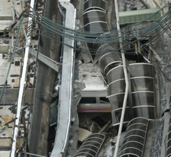 A derailed New Jersey Transit train is seen under a collapsed roof after it derailed and crashed into the station in Hoboken, New Jersey, U.S. September 29, 2016.    REUTERS/Carlo Allegri