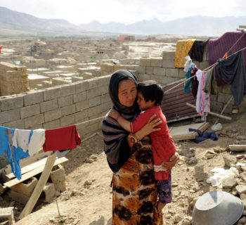 An Afghan returnee Sadiqa, 30, holds her daughter in her shetter yard in Kabul, Afghanistan, June, 11, 2012. Sadiqa and her family returned to Afghanistan 7 years ago after living for 5 years in Pakistan and are building their home by the support of Norwegian Refugee Council shelter programs in Afghanistan. 
Norwegian Refugee Council shelter program in Afghanistan targets internally displaced persons, returning Afghan refugees and host communities by providing shelter interventions include short-term emergency shelter and longer-term permanent shelter construction.
Photo by Farzana Wahidy