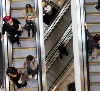 Shoppers ride escalators at the Beverly Center mall in Los Angeles, California November 8, 2013. REUTERS/David McNew/File Photo