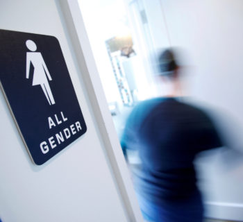 FILE PHOTO - A bathroom sign welcomes both genders at the Cacao Cinnamon coffee shop in Durham, North Carolina, United States on May 3, 2016.   REUTERS/Jonathan Drake/File Photo