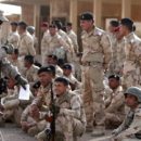 An American military trainer gives a thumbs up to an Iraqi soldier during an exercise on approaching and clearing buildings at the Taji base complex, which hosts Iraqi and US troops and is located north of the capital Baghdad, on January 7, 2015. Taji is one of an eventual five sites from which the US and allied countries aim to train 5,000 Iraqi military personnel every six to eight weeks for combat against the Islamic State (IS) jihadist group. AFP PHOTO/ AHMAD AL-RUBAYE        (Photo credit should read AHMAD AL-RUBAYE/AFP/Getty Images)